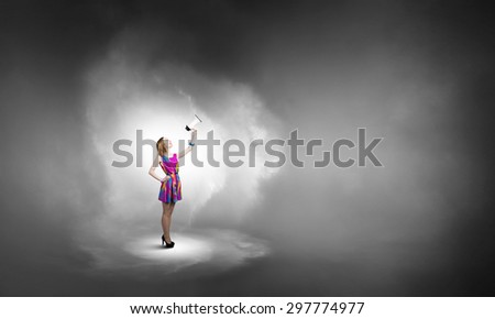 Young girl in multicolored bright dress and hat