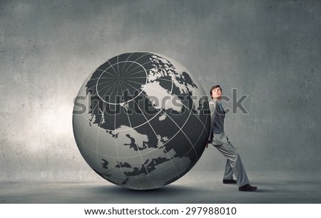 Young businessman pushing huge digital Earth planet