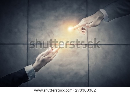 Top view of two businesswpeople reaching fingers to touch each other