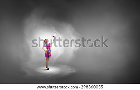 Young girl in multicolored bright dress and hat