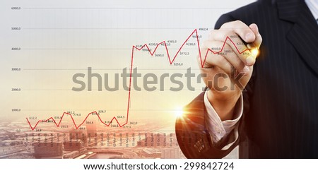 Chest view of businessman drawing with pencil increasing graph