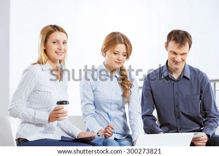 Three co-workers discussing business ideas in office