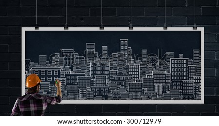Rear view of businessman drawing business plan on banner