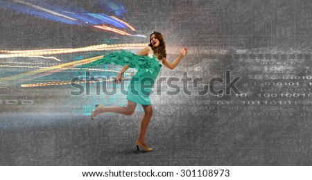 Young businesswoman in dress running in a hurry