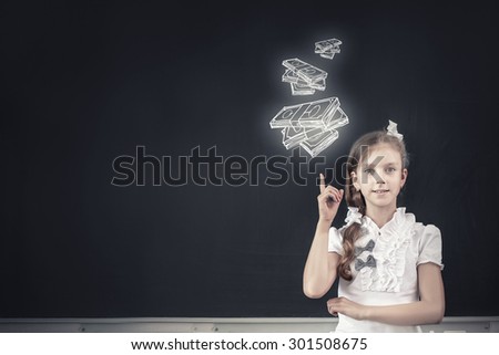 Cute school girl and drawn money banknotes on blackboard