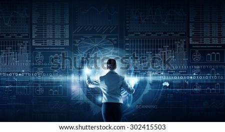 Back view of businesswoman working with modern virtual technologies