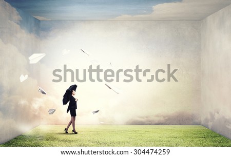 Bad luck and crisis concept with young businesswoman with black umbrella