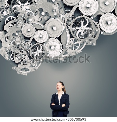 Young businesswoman with closed eyes thinking something over