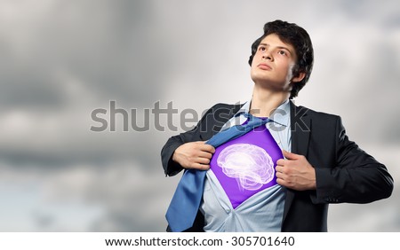 Businessman opening his shirt on chest acting like super hero