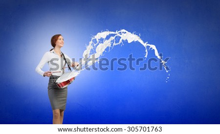 Young businesswoman playing drums and white splashes of paint