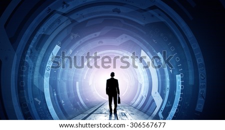 Back view of businessman with suitcase in hands looking at virtual panel