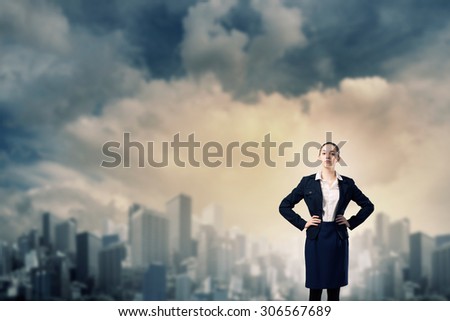 Young confident businesswoman with hand on waist