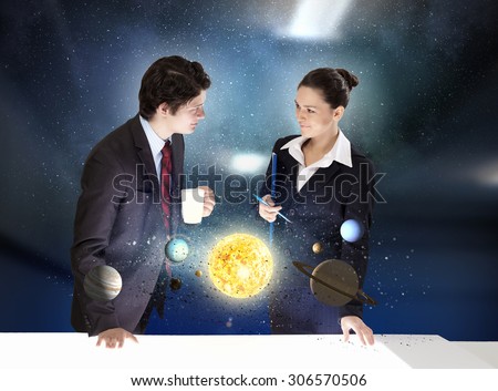 Young businesswoman and businessman and planets of space spinning around
