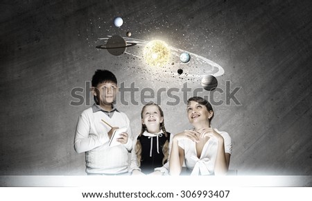 Cute boy of school age and teacher exploring space system