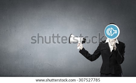 Unrecognizable businesswoman hiding her face behind mask and screaming in megaphone