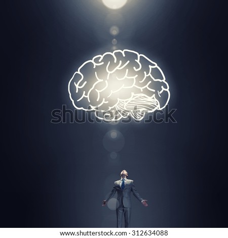 Businessman with hands spread apart and big human brain