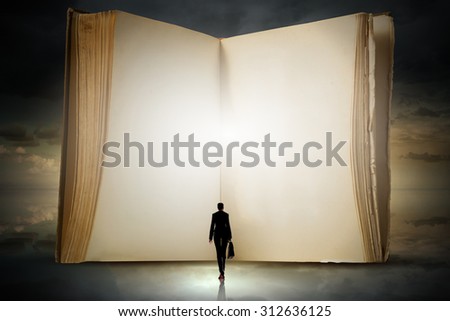 Big old opened book and miniature of businesswoman