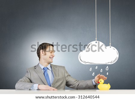 Funny businessman with yellow rubber duck toy