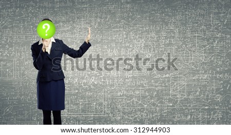 Businesswoman hiding her face behind paper mask with question sign and showing stop gesture