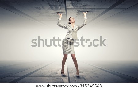 Young troubled businesswoman trapped between two walls