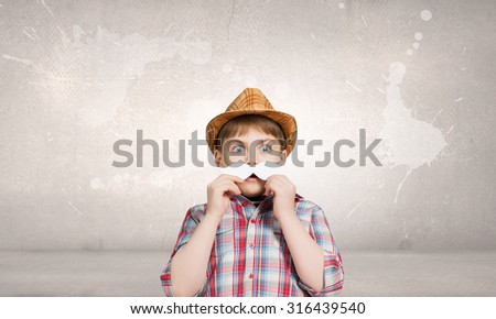 Cute boy wearing shirt hat and mustache