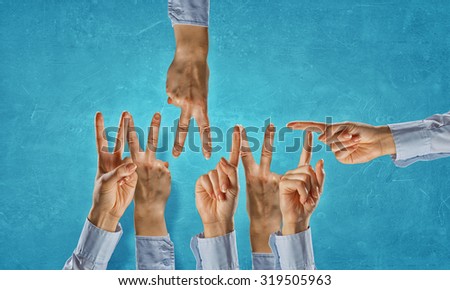 Many hands of business people making word
