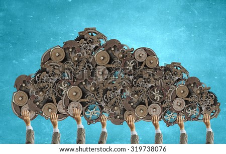 Hands of businesspeople holding gears engine mechanisms