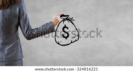 Back view of businesswoman holding drawn money bag