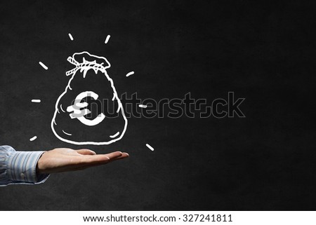 Businessman hand holding drawn money bag in palm