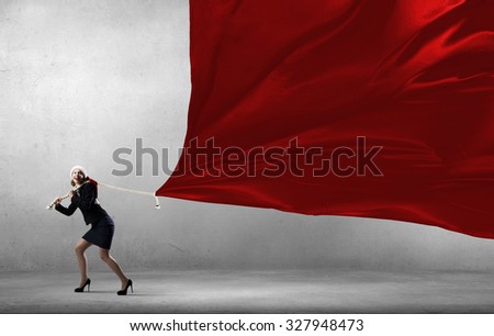 Santa woman in suit pulling red clothing banner