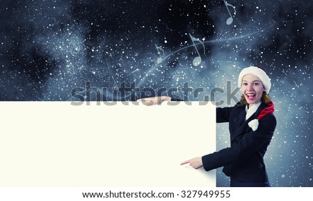 Santa woman pointing with finger at blank banner. Place for your text
