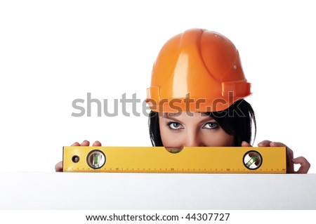 The young charming girl the builder with the measuring tool isolated on white