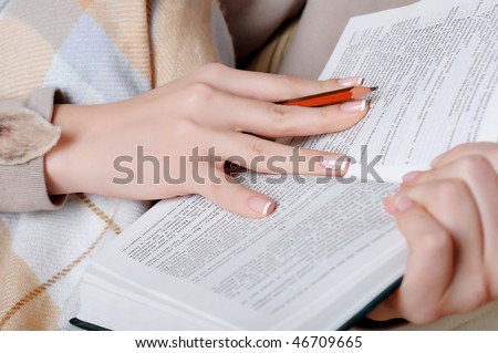 hands of a young girl reading a book