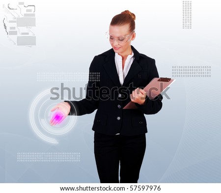 Business woman in a dark suit and transparent glasses clicks on virtual buttons. Collage - a symbol of high-tech future