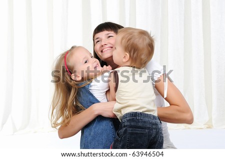 A young mother, her daughter and son having fun together
