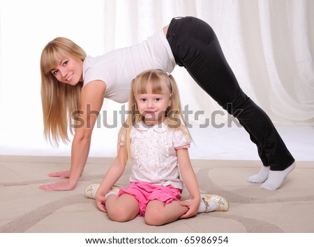 The little girl and her mother engaged in sports