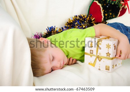 the little boy fell a sleep on the couch waiting for a holiday. Happy New Year and Merry Christmas!