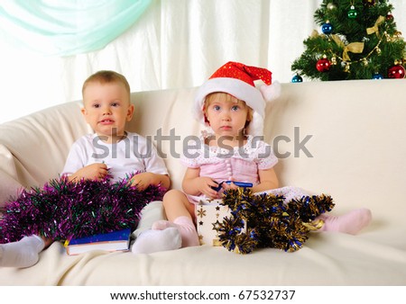two small children - a boy and girl getting ready for the holiday. Happy New Year!
