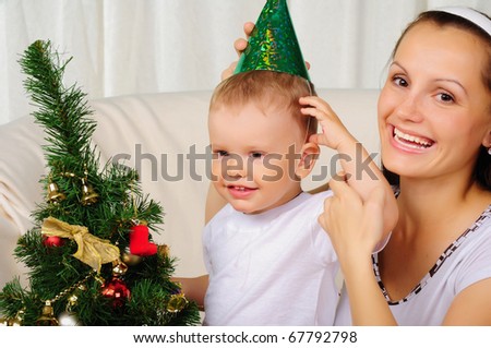 Young mother and her son are preparing for the holiday together. Happy New Year!