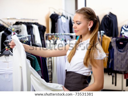 young girl in a shop buying clothes