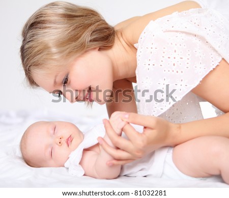 Portrait of a young mother and baby and a girl in her arms
