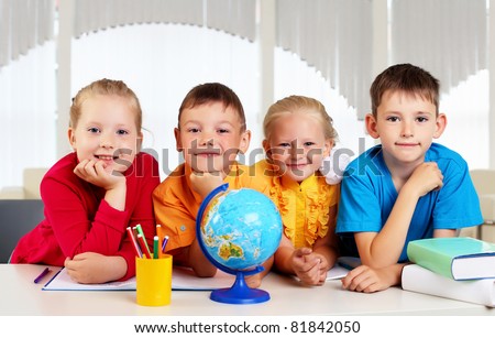 Group of pupils studying a globe together