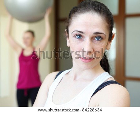 young woman in sport wear exercising in sport club