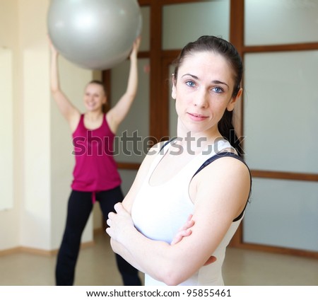 young woman in sport wear exercising in sport club