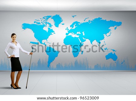 Businesswoman with paint brush and world map on the background