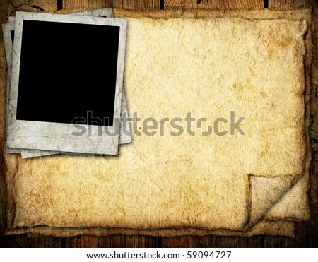 Paper sheet and old photo frame on wooden background