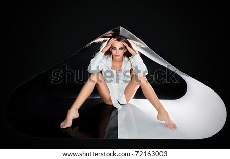 Young beautiful sexy lady with long hairs in abstract plastic tube, ring flash fashion portrait