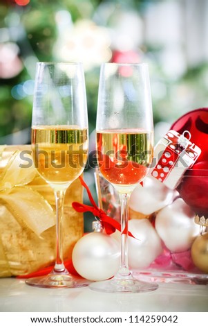 Glasses of champagne and Christmas decorations in front of Christmas tree for the holidays