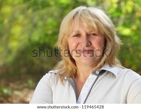 Middle aged woman looking at camera with happy smile