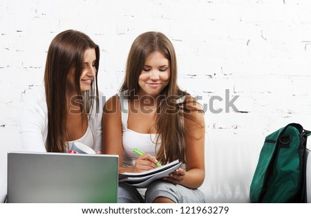 Casual dressed high school student girl study near laptop